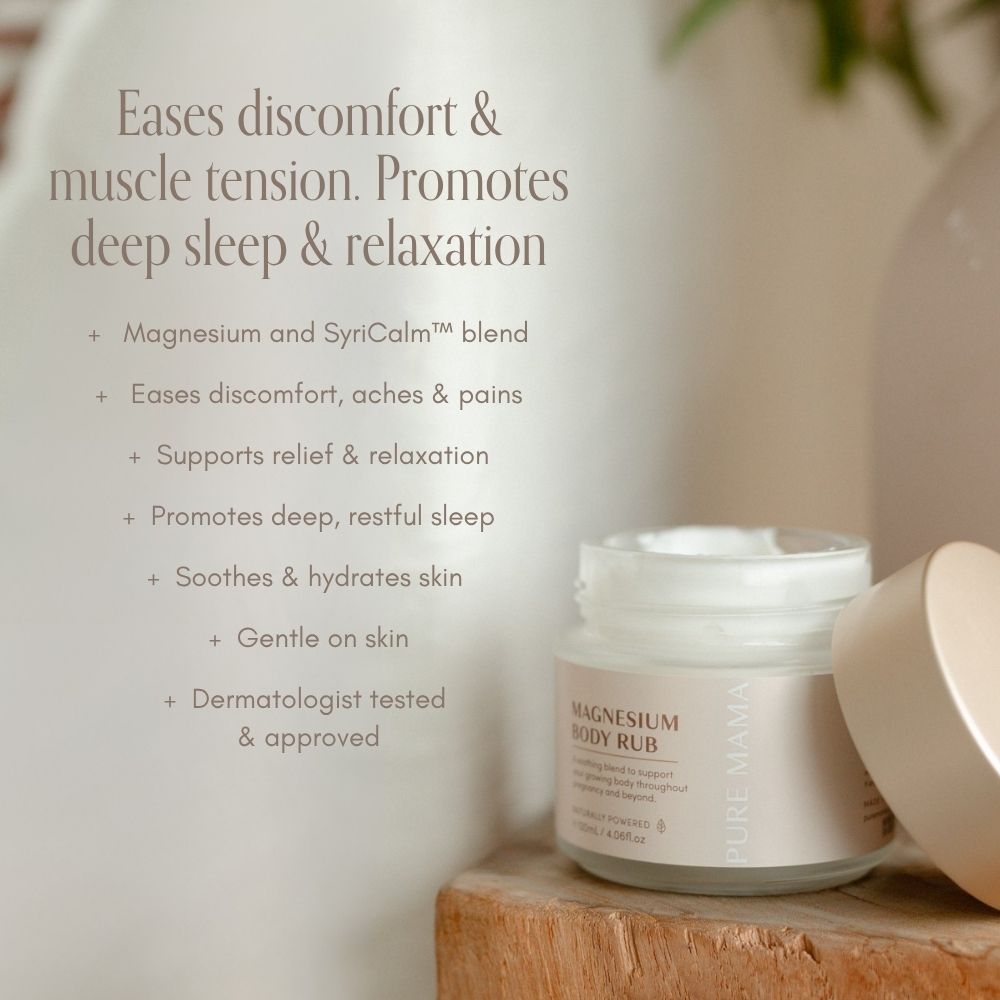A jar of Pure Mama Magnesium Body Rub sits open on a wooden surface, with text beside it noting benefits such as easing aches and pains, promoting sleep, relaxing muscles, and being dermatologist tested—set against a calm background.