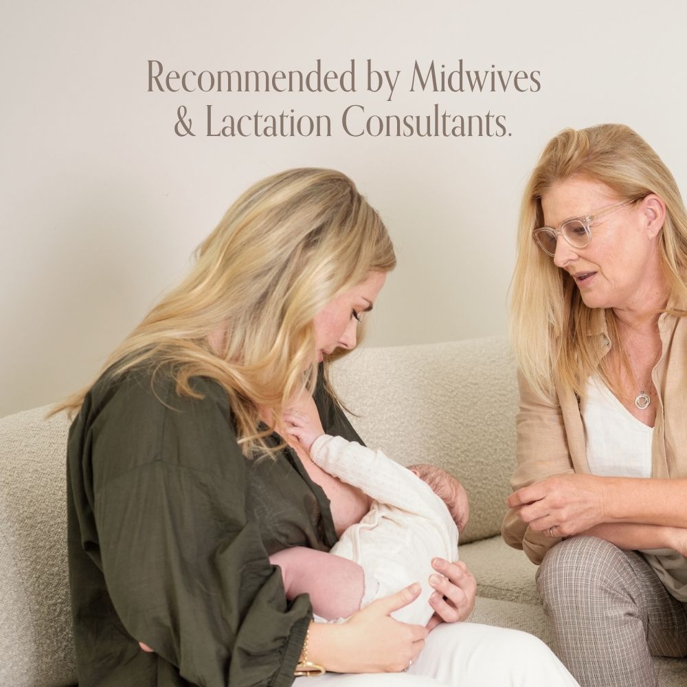 A woman breastfeeds her baby on a couch with support from another woman. Text above reads, Pure Mama NZ Nipple Butter—recommended by midwives and lactation consultants for breastfeeding.