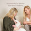 A woman breastfeeds her baby on a couch with support from another woman. Text above reads, Pure Mama NZ Nipple Butter—recommended by midwives and lactation consultants for breastfeeding.