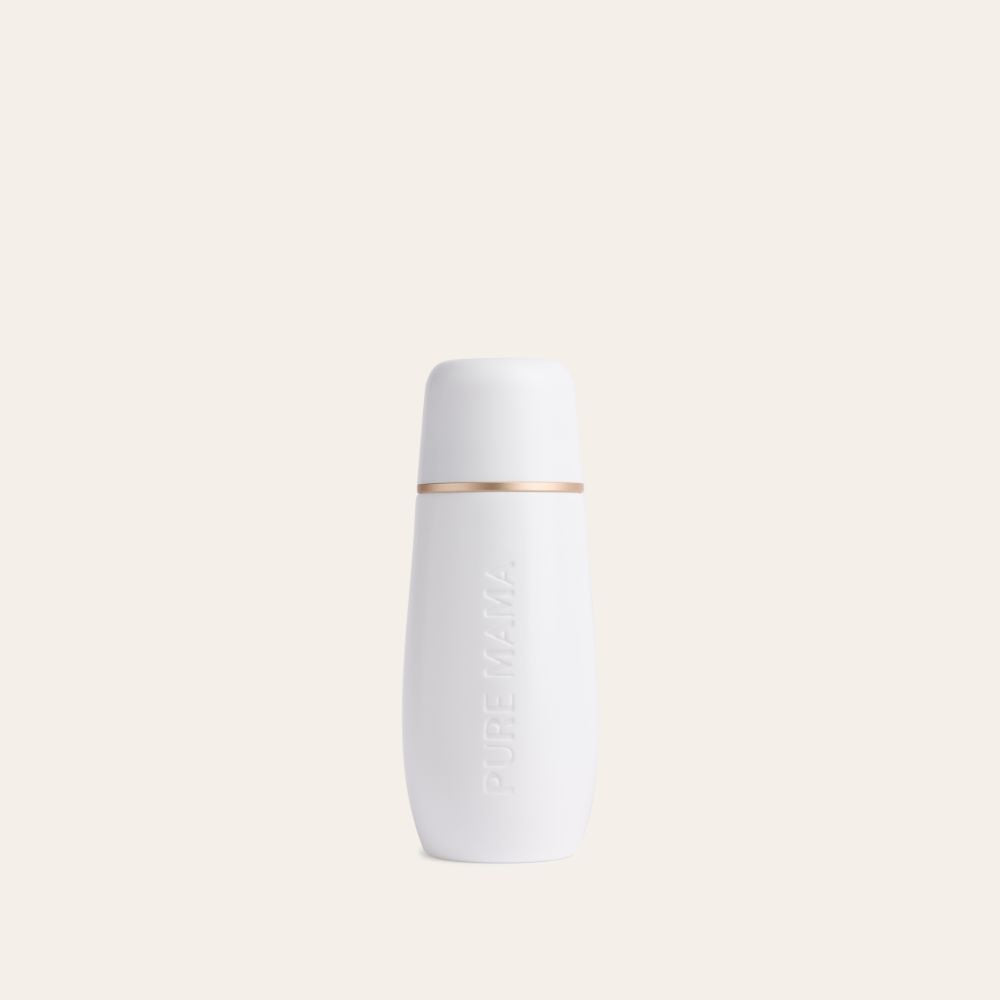 A white Pure Mama NZ Peri Wash Bottle with an ergonomic design and a gold band near the top, embossed with PURE MAMA, is placed against a plain light beige background.