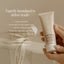 A hand holds a tube from the Pure Mama NZ Belly Spa Kit against a neutral background. Text highlights gentle exfoliation, hydration, scar improvement, antioxidants, and 100% natural fragrance—perfect for pregnancy self-care.