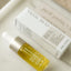 A small dropper bottle labeled Belly Oil Mini by Pure Mama NZ, designed for skin elasticity and stretch mark care, sits beside its box on a light surface, showing off the yellow oil inside.